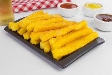 Traditional Brazilian recipe fried polenta in white background
