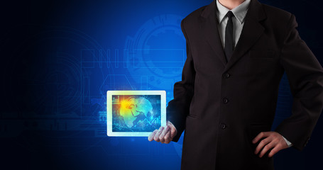 Hand holding tablet with global database concept