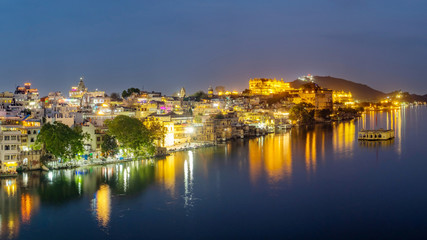 Udaipur city at lake Pichola in the evening, Rajasthan, India. View of City palace reflected on the lake.