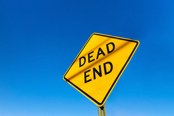 Dead end road sign on a blue clear sky day.