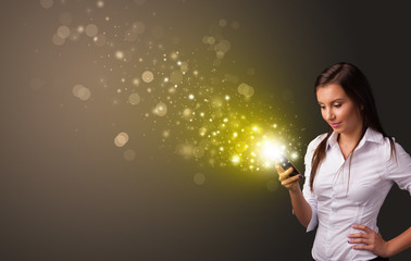 Person using phone with gold sparkling concept