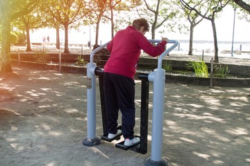 happy senior woman doing exercises and fitness outdoors