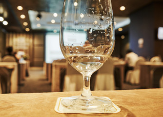 Cpnference hall at the background and the glass of water at the foreground