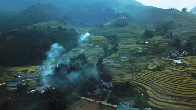 sapa landscape on the evening. Smoke rising from burning rice fields, drone dolly in shot