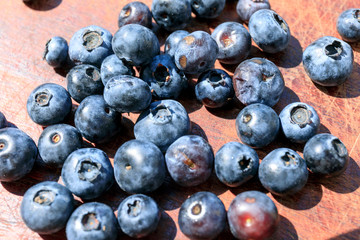 Blueberry on wooden table background. Ripe and juicy fresh picked blueberries closeup. 