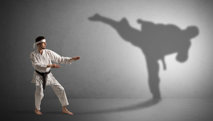Fototapeta na wymiar Young karate man confronting with his own shadow
