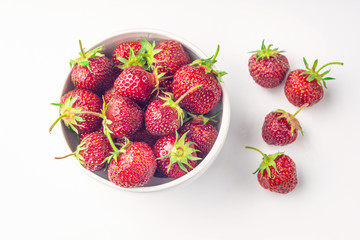 Red fresh strawberry in a bowl isolated on white background