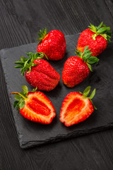 Fresh strawberries on dark background.