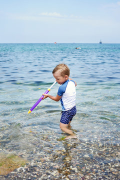 little boy playing in sea