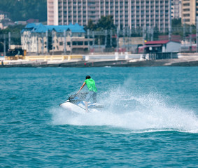 Naklejka premium A man rides a water bike in the water