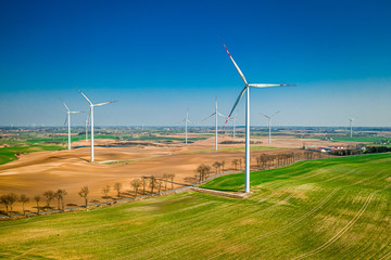 Big wind turbines in a field, aerial view of Poland