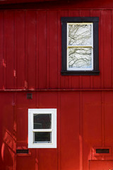 Obraz na płótnie Canvas Cottage windows in red, Red wall, white frame windows, retro Background