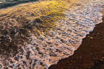Waves on the seashore at sunset