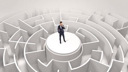 Businessman standing on the top a maze and looking through