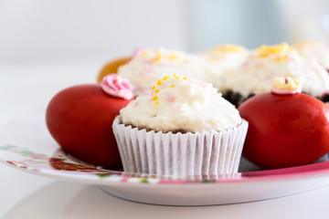 Easter bread cake and painted red eggs on a plate.