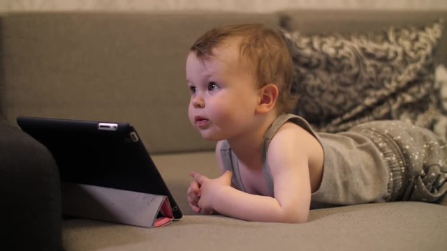 Little boy looking on tablet PC