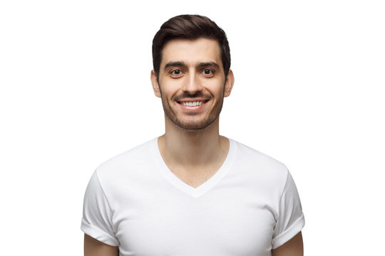 Portrait of handsome smiling young man in casual t-shirt, looking at camera, isolated on white background