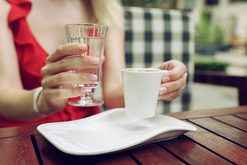Close up of beautiful female hands with coffee in traditional Turkish style.