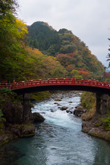 Shinkyo bridge with stream river and autumn tree beautiful nature landscape.