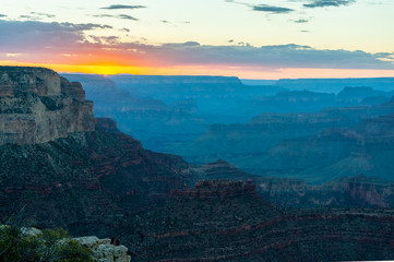 The setting sun sinking below the horizon of the Grand Canyon, near Yavapai point on the southern canyon rim.