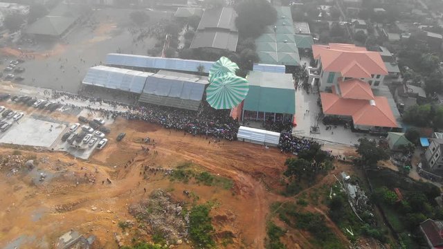 Aerial view of a bunch of people gathered and celebrating mass at the church of Ngi Loc.,Vietnam.