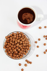 chocolate corn balls in a glass plate and cocoa mug for breakfast