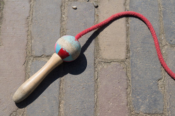 vintage jump rope with red rope and wooden bead