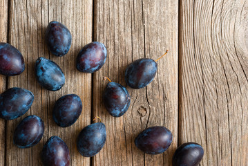 plums on old wood table directly above