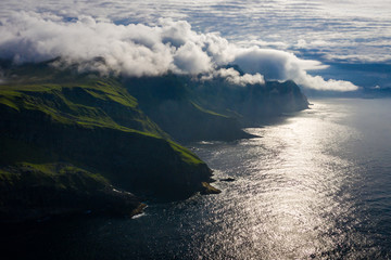 Aerial view of Mykines island in Faroe Islands, North Atlantic Ocean. Photo made by drone from above. Nordic natural landscape.