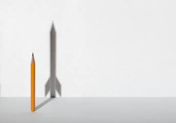 Pencils and a shadow in form of spacecraft . Success, cureer and solving problems business concept....