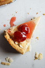 Coconut custard pie with strawberry jam on marble background