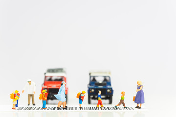 Miniature toys school kids walk on cross road bar code - school children road safety concept - ...