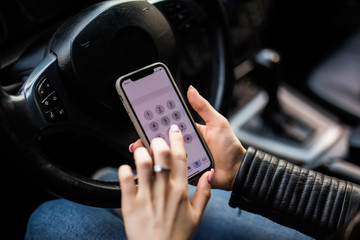 Close up of woman using smartphone while driving car
