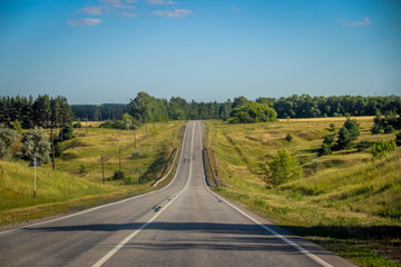 Russian asphalt roads. Highway. Road trip. The car goes on the road. Background asphalt road.