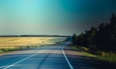 Obraz na płótnie Canvas Russian asphalt roads. Highway. Road trip. The car goes on the road. Background asphalt road.