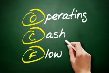 OCF - Operating Cash Flow acronym, business concept on blackboard