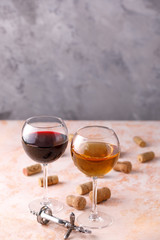 Glasses of white and red wine. The concept of winemaking. Place under your text. Still life on a textural background.