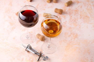 Glasses of white and red wine. The concept of winemaking. Place under your text. Still life on a textural background.
