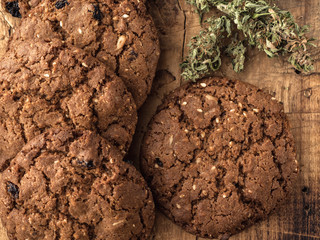 cannabis and textured cookies on a wooden board. close-up.