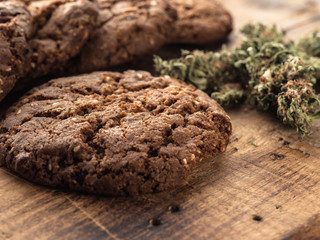 textured chocolate hemp oatmeal cookies on a wooden board