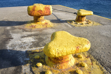 Greece, the island of Sikinos. The port of Aloprina.  Bollards on the dockside for securing ferries when they dock.