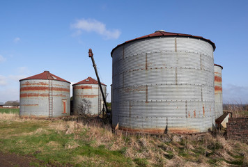 A group of Old and unused 1940's style Corrugated metal Silo's beside a rural minor road near Gardyne, Letham in Angus Scotland. © Julian