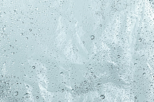Plastic bag and wet surface with water droplets background. Abstract of dew wallpaper.