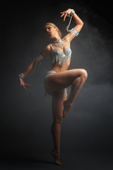 Fototapeta premium Slender girl blonde in a beautiful costume dancing Oriental dance.