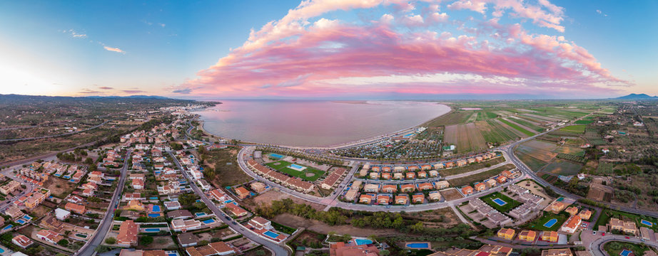The incredible sunset over the bay of L'Ampolla and Deltebre, Catalonia, Spain. Drone aerial panorama