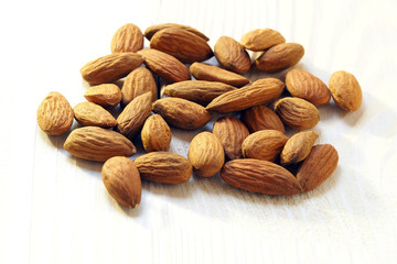 almond nuts on a light wooden surface