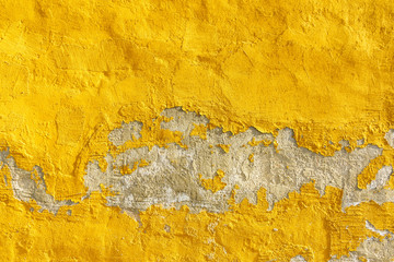 Old weathered painted yellow color peeling wall grunge background