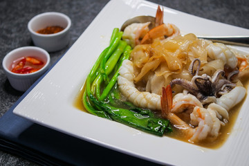 Fried noodle with sea food and kale in gravy