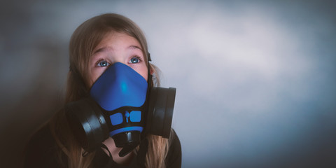 Young girl wearing gasmask, respirator portrait. Effects of worldwide air pollution, industrial...