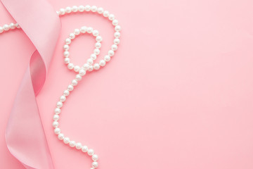 Feminine desktop mockup with pearls and pink ribbon on pink background